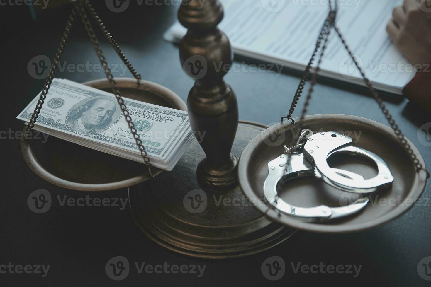 Justice and law concept.Male judge in a courtroom with the gavel, working with, computer and docking keyboard, eyeglasses, on table in morning light photo