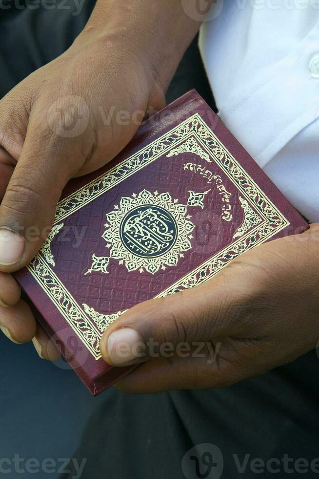 The Koran in the hands of a man photo