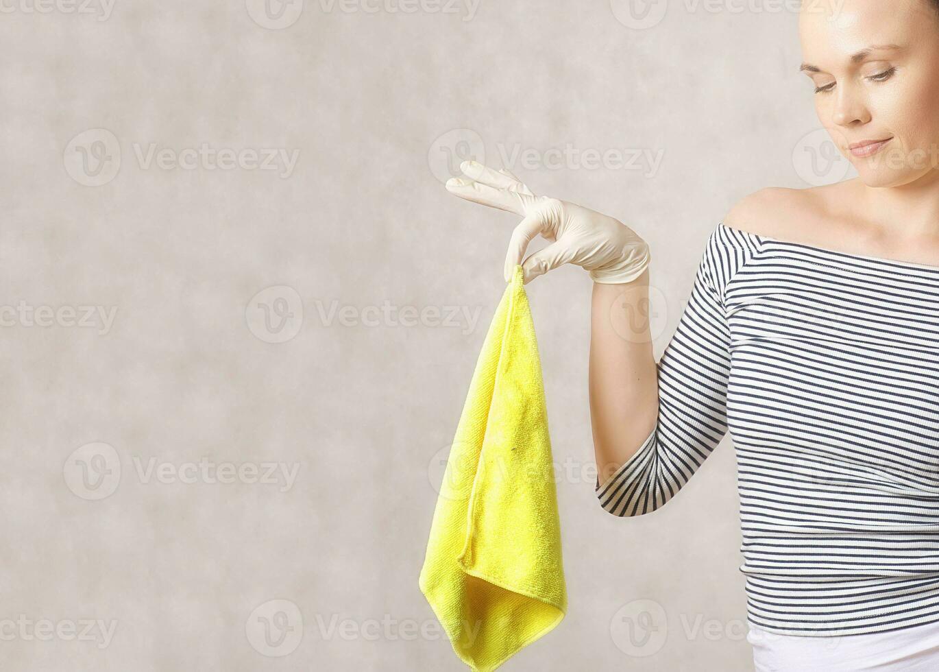 A young attractive woman between 30 and 40 years old keeps a microfiber. photo