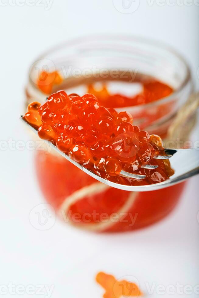 Red caviar on a metal fork. photo