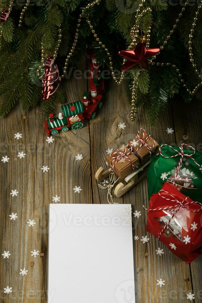 Blank sheet of paper on a new year's background. , Blank sheet of paper and Christmas present on a new year's background. photo