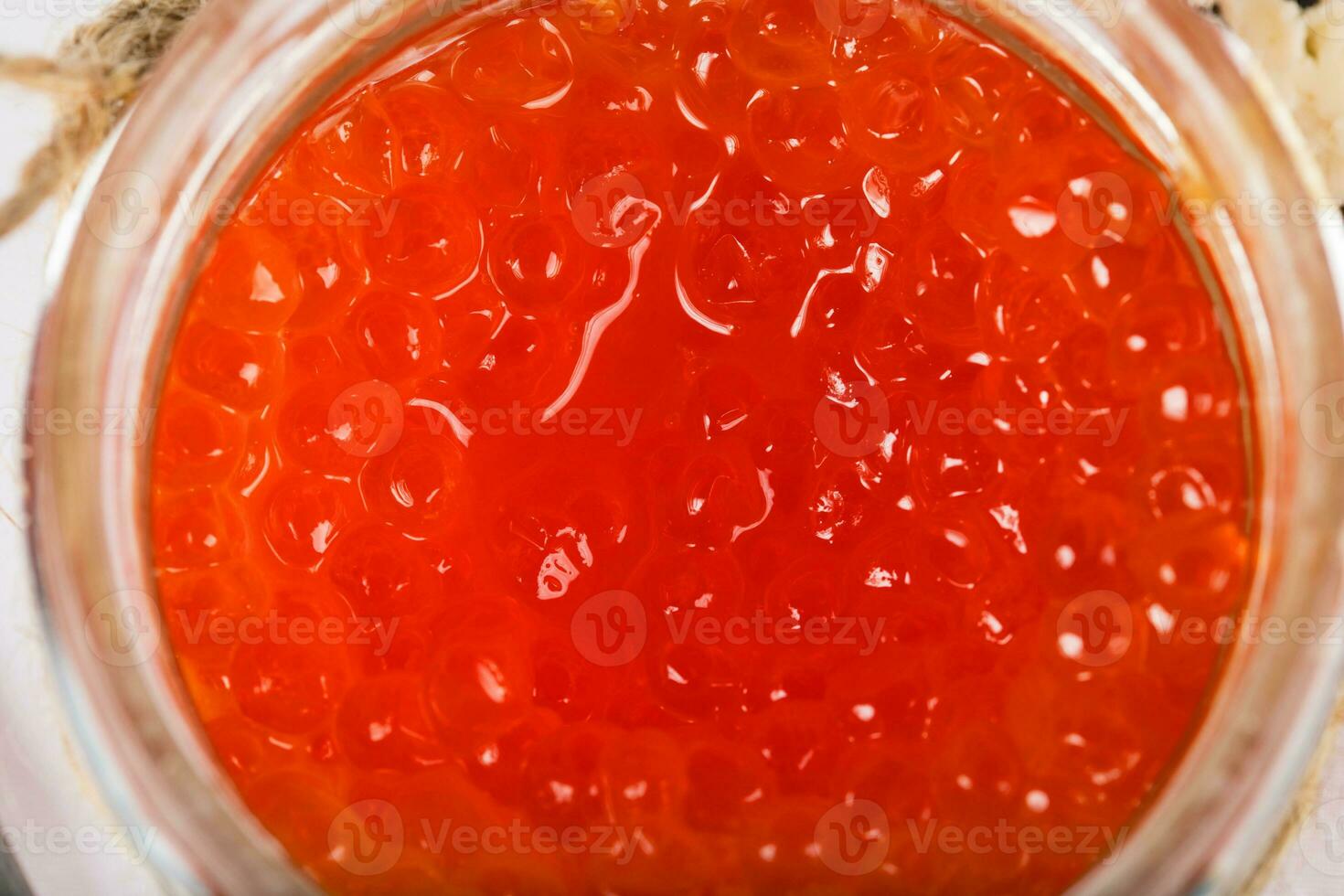 Red caviar in the glass bottle. photo