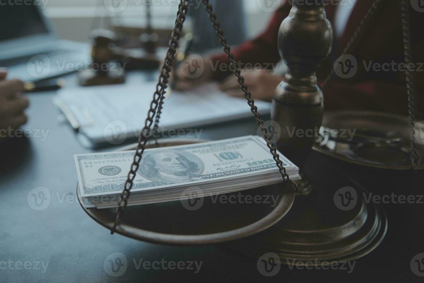Justice and law concept.Male judge in a courtroom with the gavel, working with, computer and docking keyboard, eyeglasses, on table in morning light photo