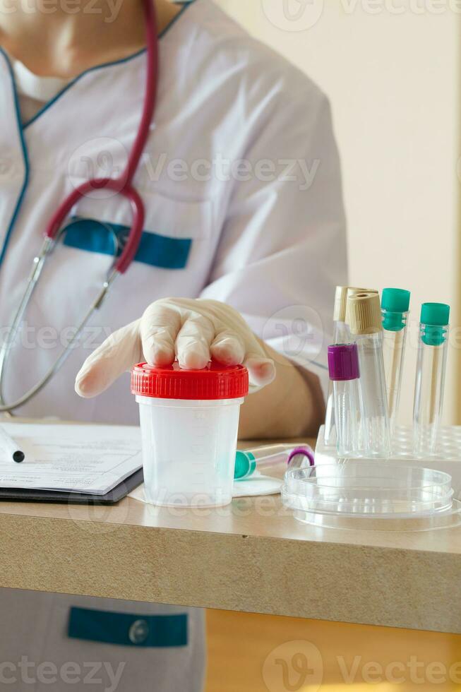 Collection cup for routine urine test. Closeup photo