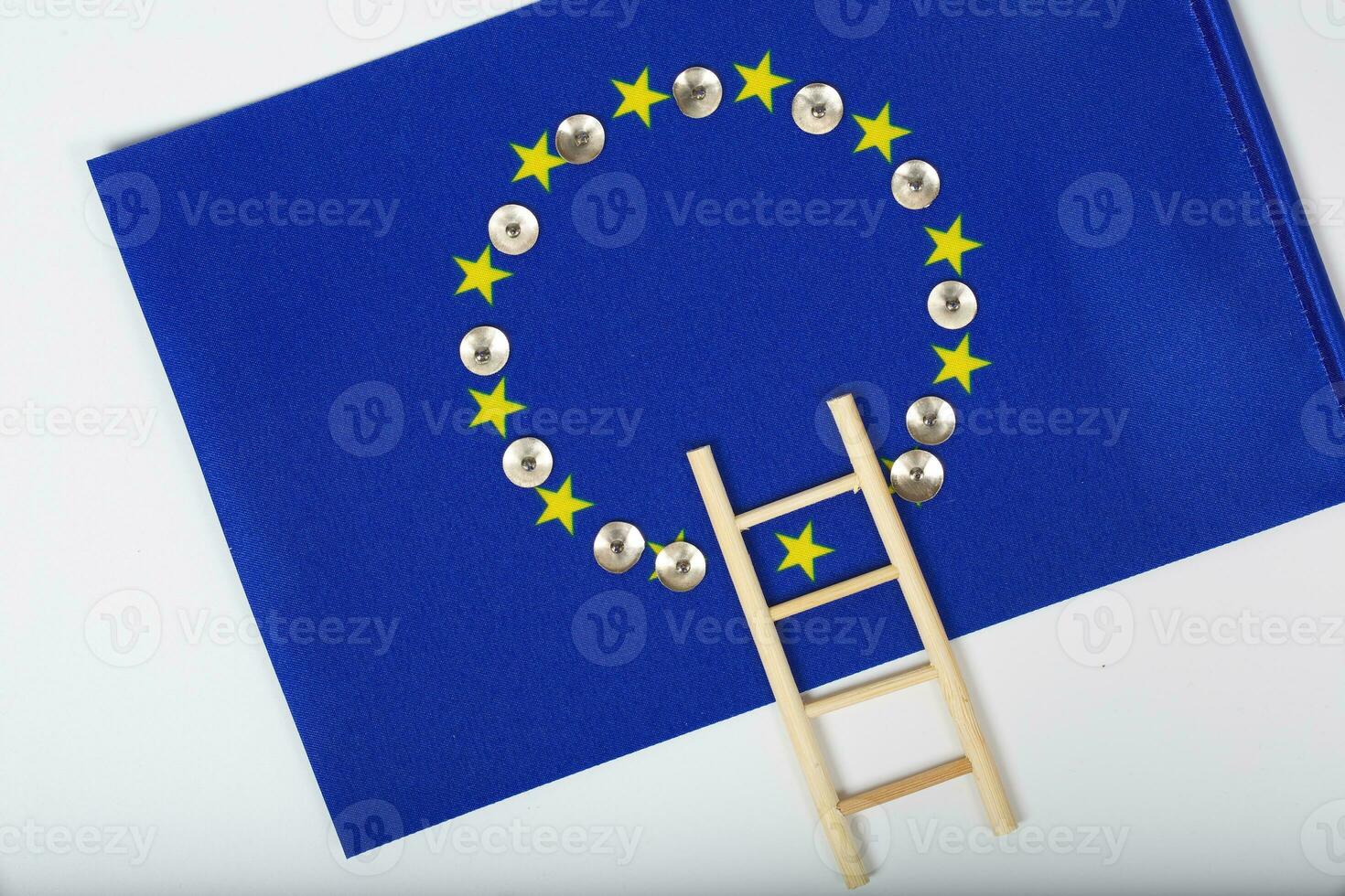 Ladder and pins on an European flag. Closeup photo