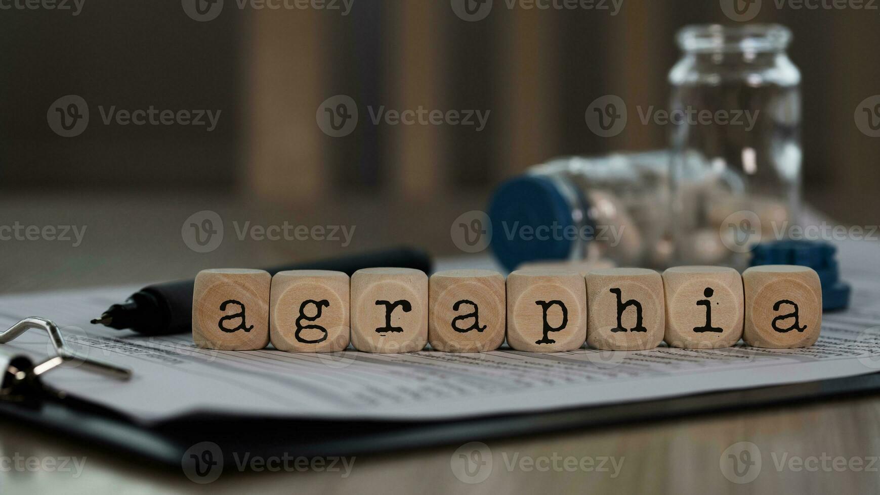Word AGRAPHIA composed of wooden dices. photo