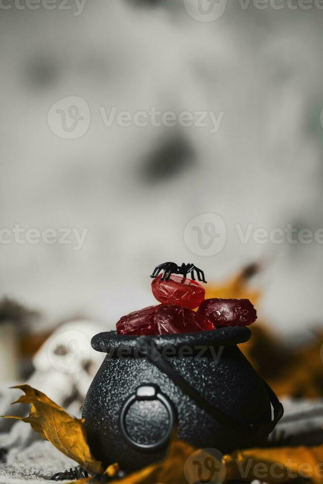 Candies in caldron for Halloween photo
