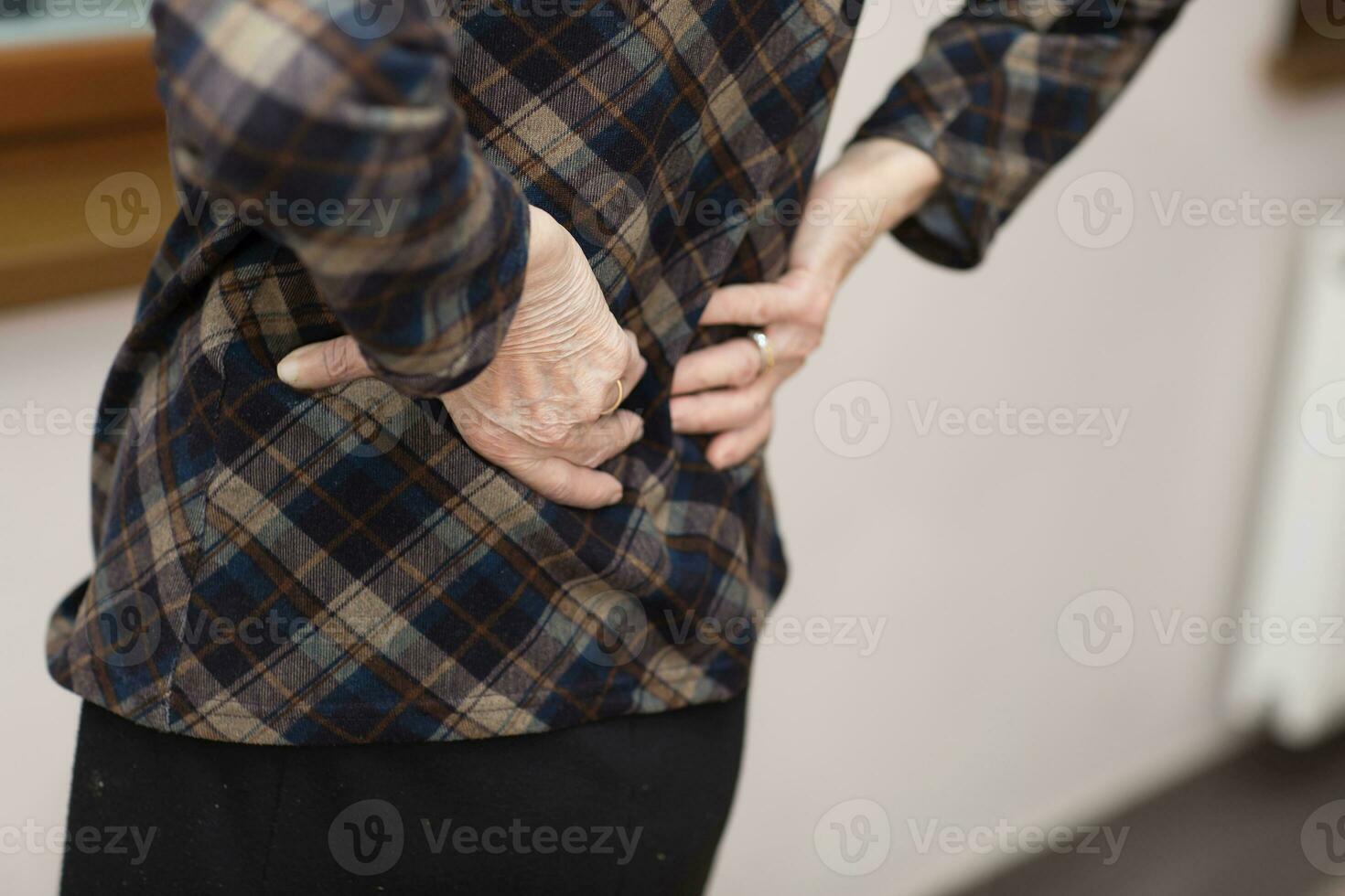 Old woman has backache. photo