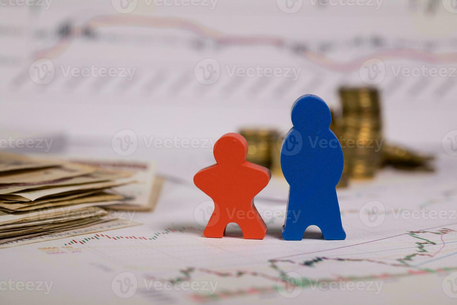 Wooden figurines in red and blue on a diagram. photo