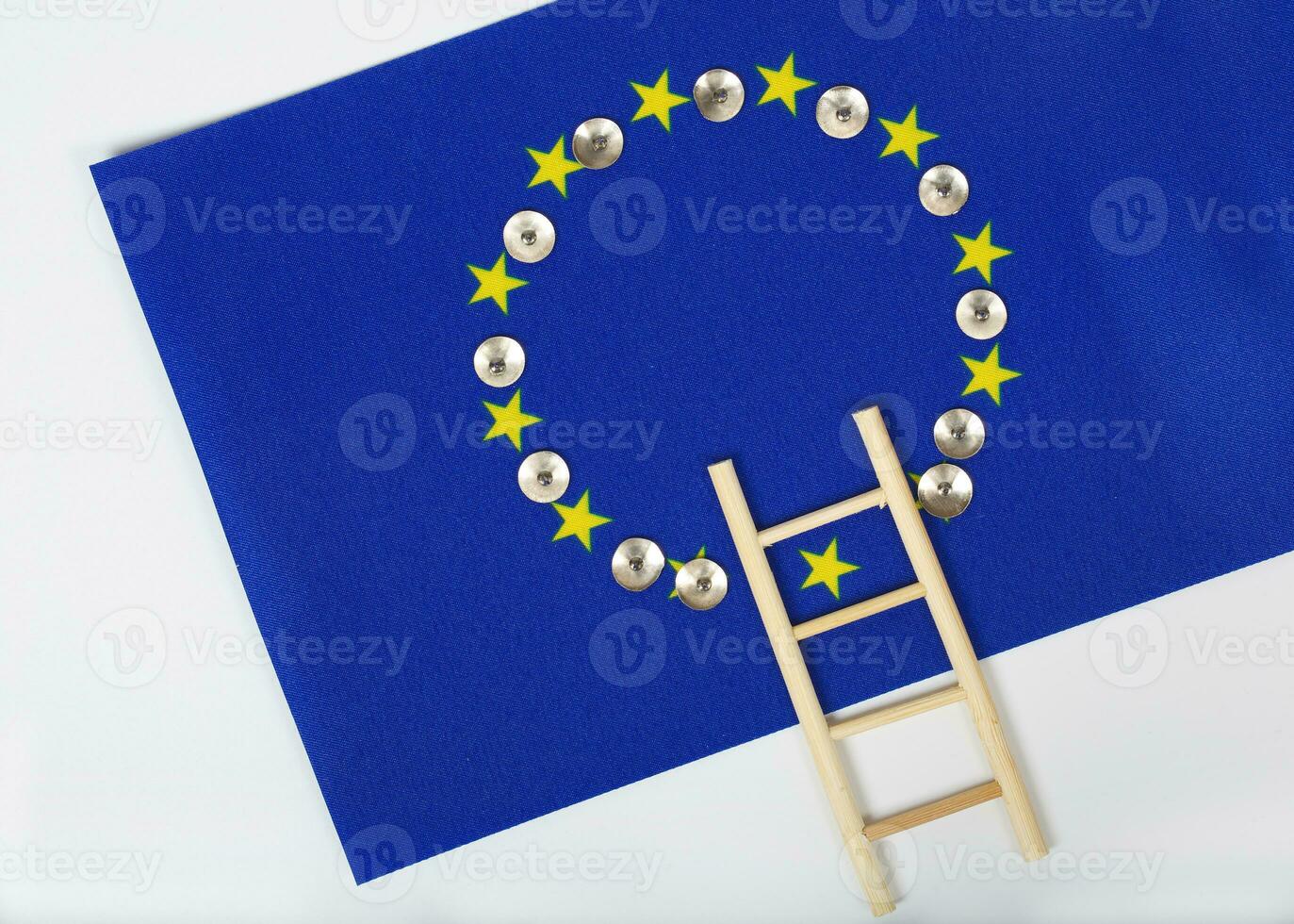 Ladder and pins on an European flag. Closeup photo