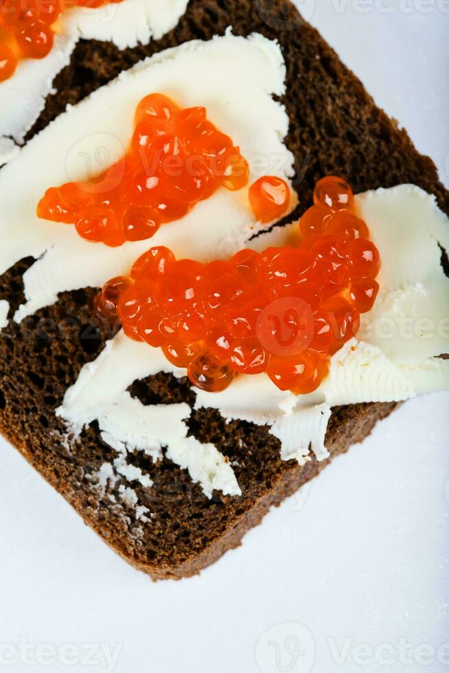 Cereal black bread with butter and red caviar. photo