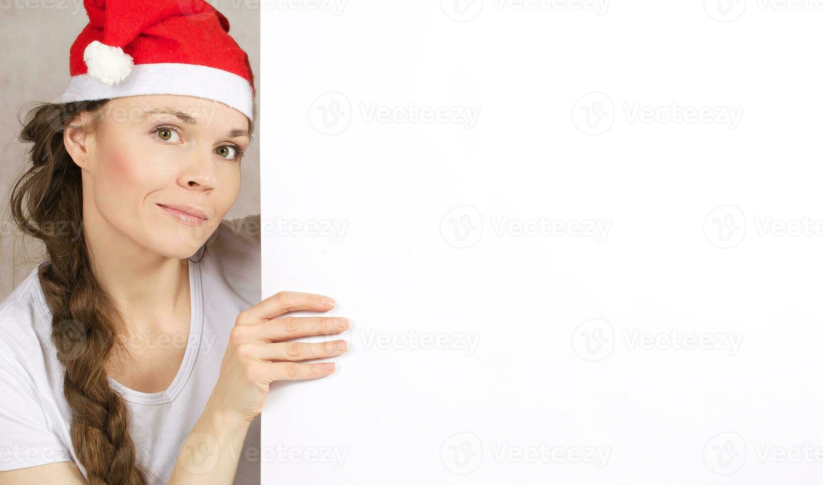 Young lady in Santa Claus hat photo