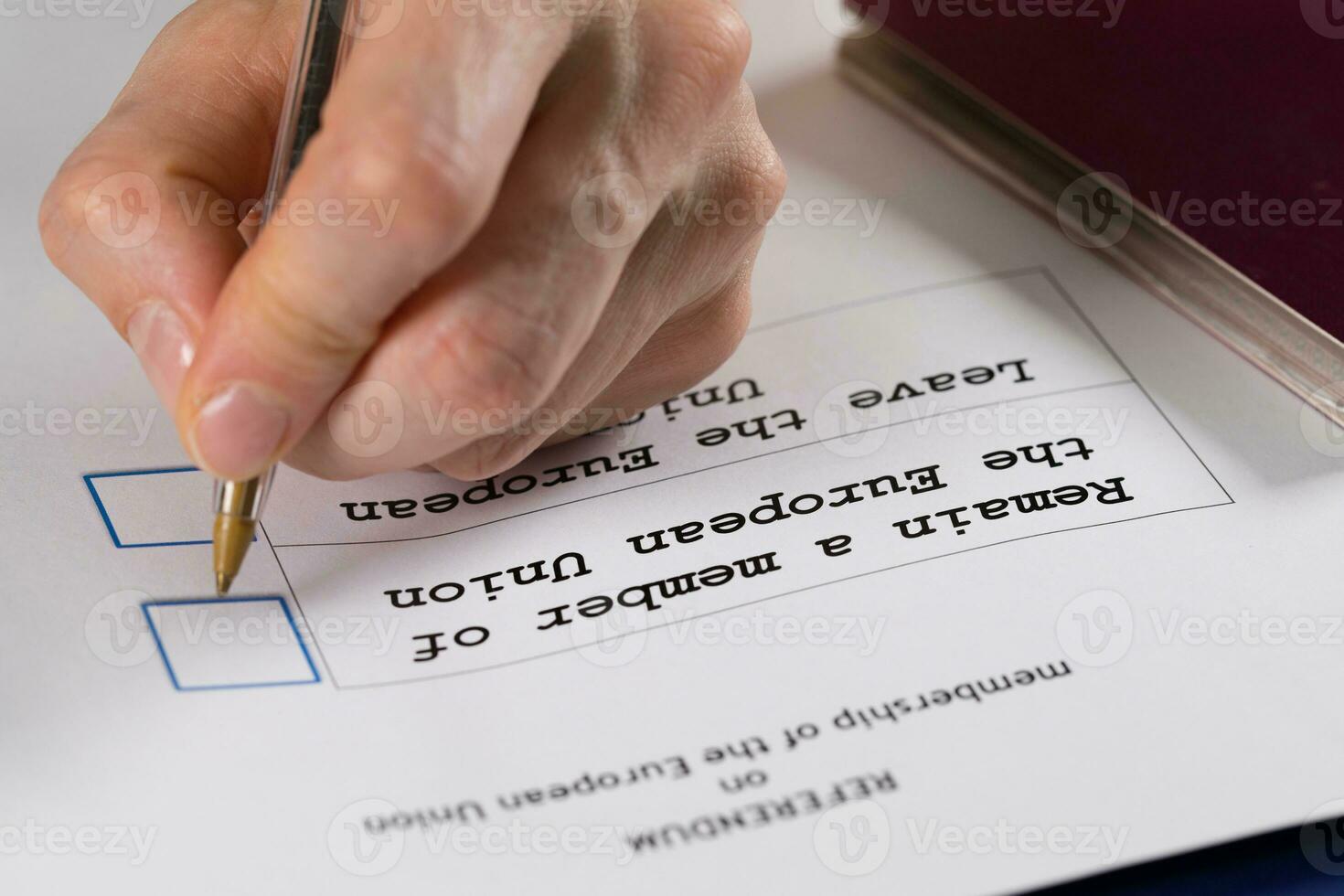 Referendum ballot paper, black pen, and passport on the table. photo