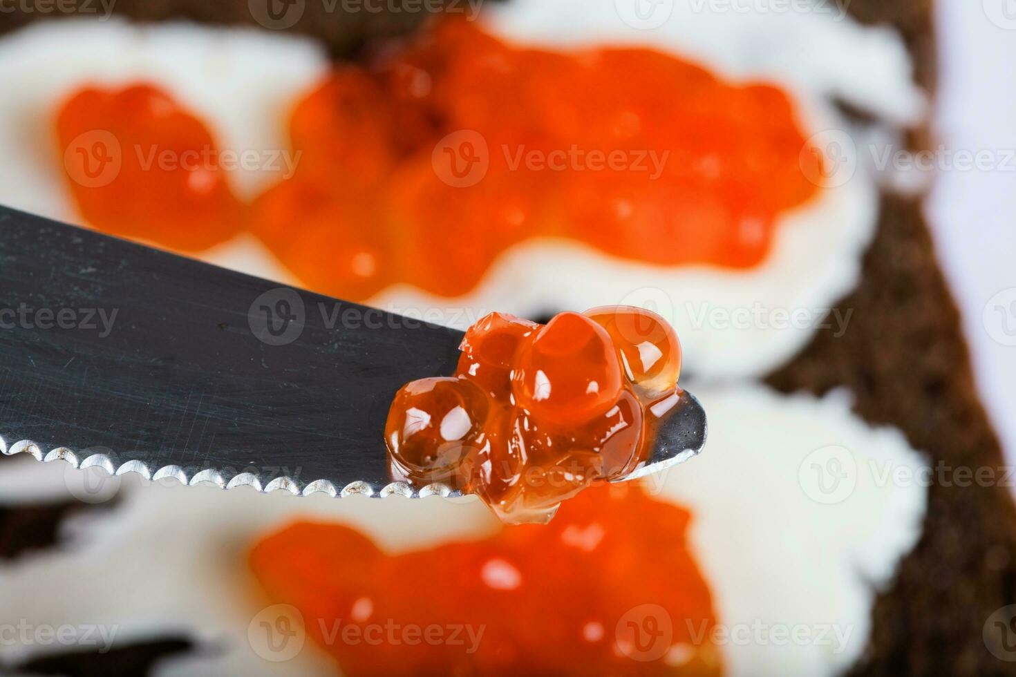 Cereal black bread with butter and red caviar. photo