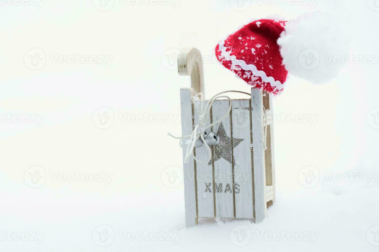 Santa Claus hat on a wooden made sleigh. photo