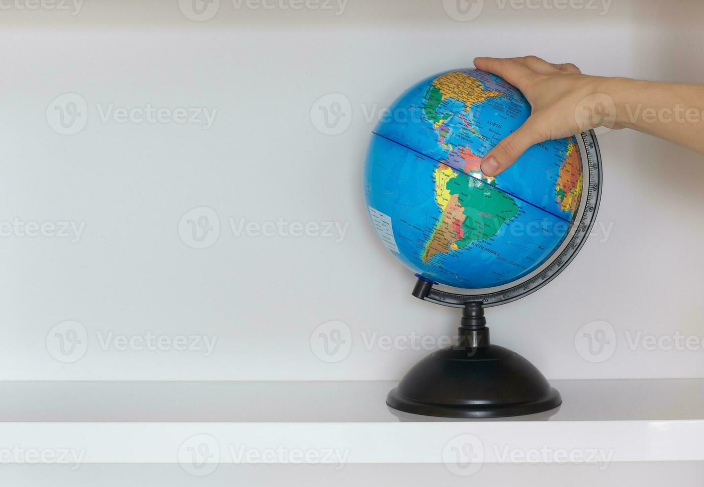 Colorful paper globe on a book shelf. photo