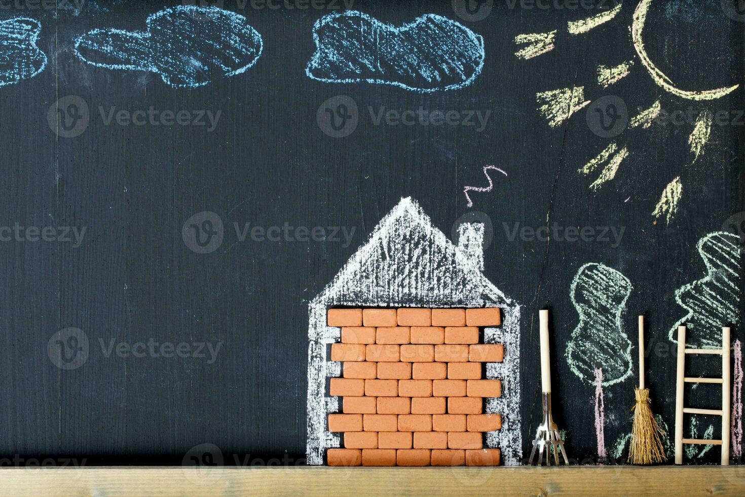 Painted house and the yard in a colourful chalk. Closeup photo