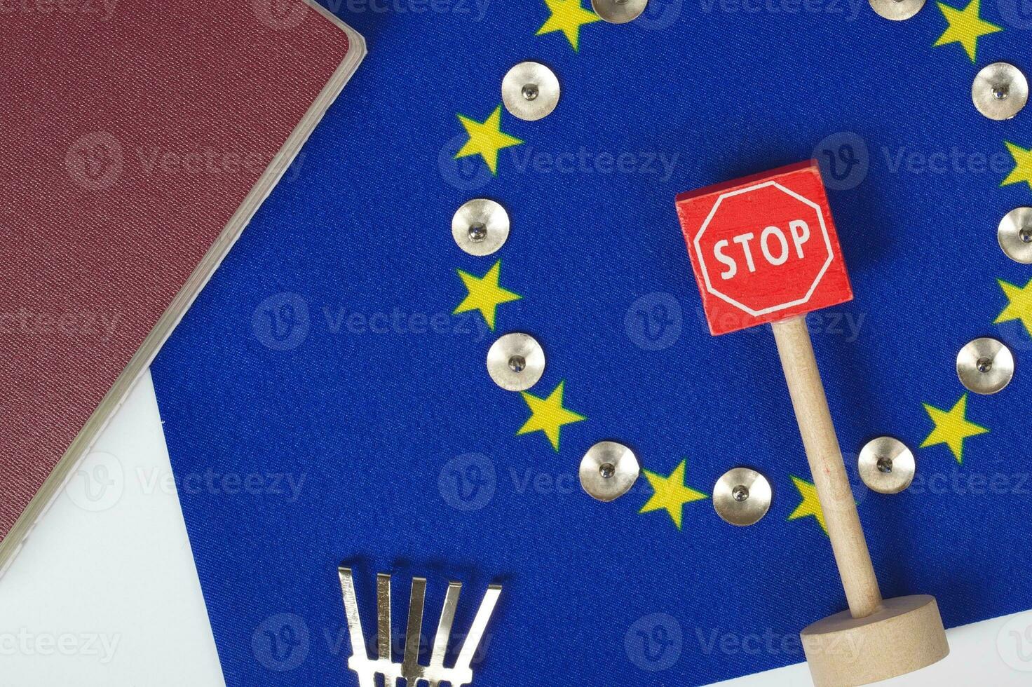 Agricultural tools,a card with access forbidden,pins,and a passport on an European flag.Closeup photo