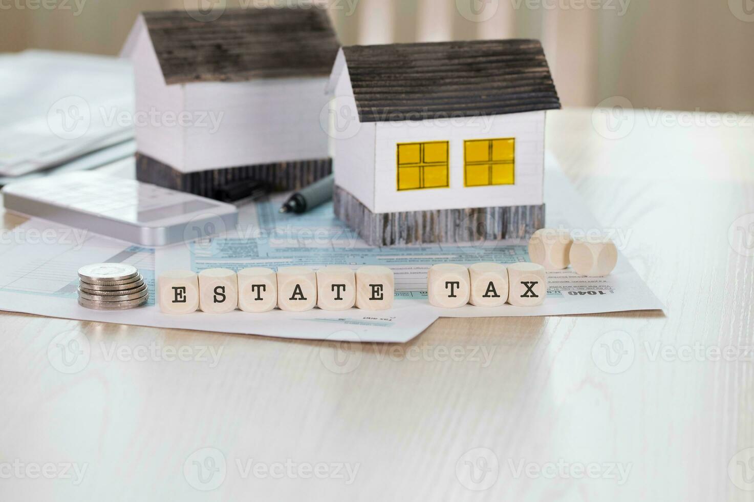 Word ESTATE TAX is composed of wooden letters. photo