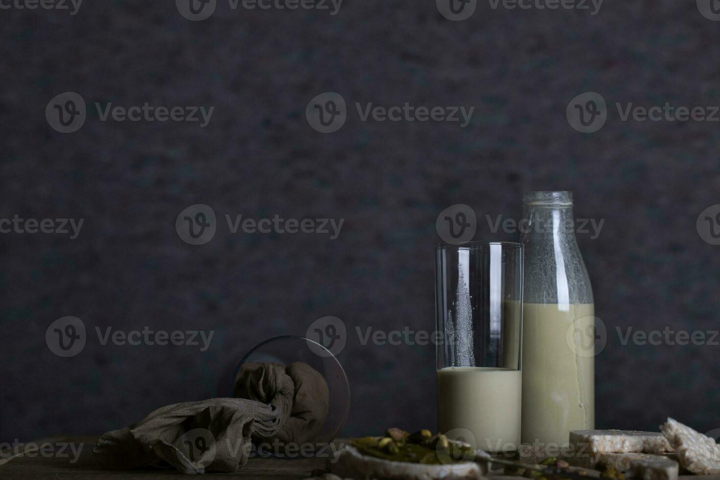 Homemade pistachio nut milk in a glass bottle. photo