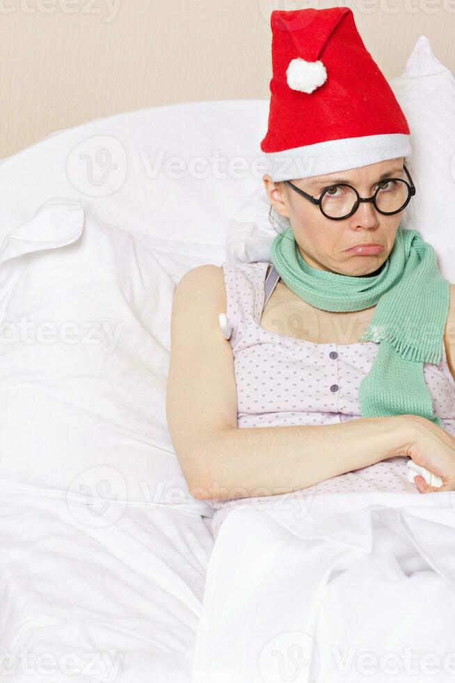 Sick angry lady in her bed in winter holidays photo