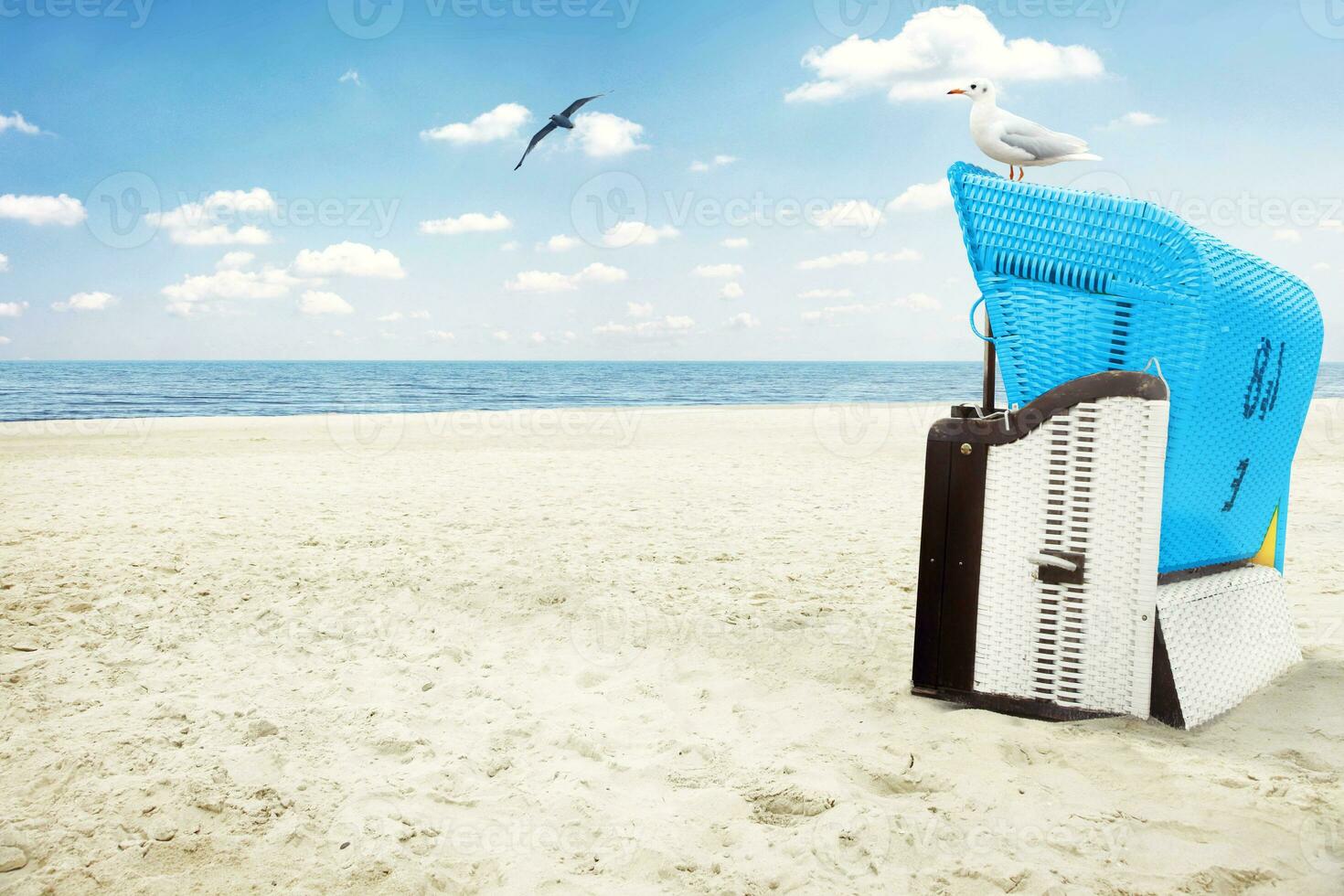 Stormy baltic sea with beach chairs and coastal dunes. photo