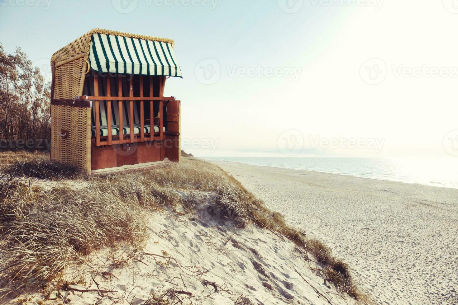 Stormy baltic sea with beach chairs and coastal dunes. photo