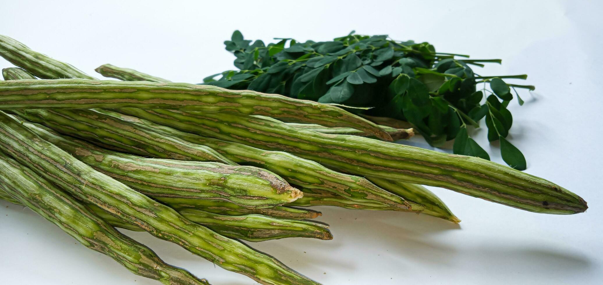 Healthy green vegan super food- Fresh harvested organic Moringa, Limaran, ben-oil, drum stick, horseradish tree, or Malunggay  vegetable. In Indonesia this vegetable is called Sayur Klentang. photo