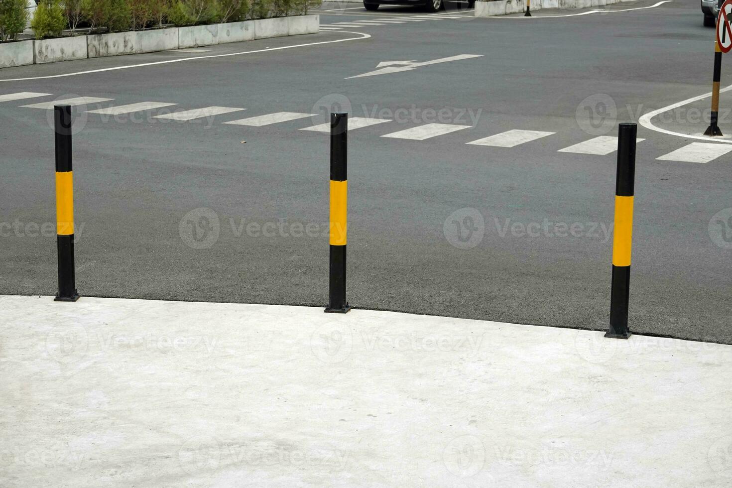 Protective yellow fence for pedestrians in front of the park photo