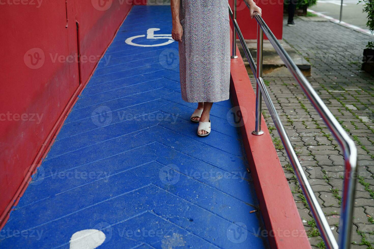 Asian elderly old woman patient use support rail on ramp, handrail safety grab bar, security in nursing hospital. photo