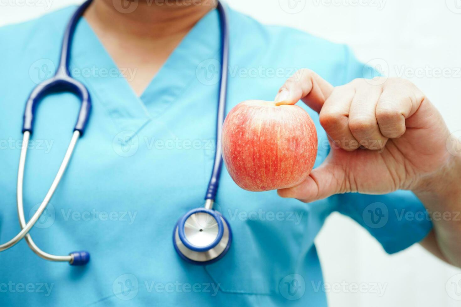 Asian Nutritionist holding apple healthy food for patient in hospital, nutrition and vitamin. photo