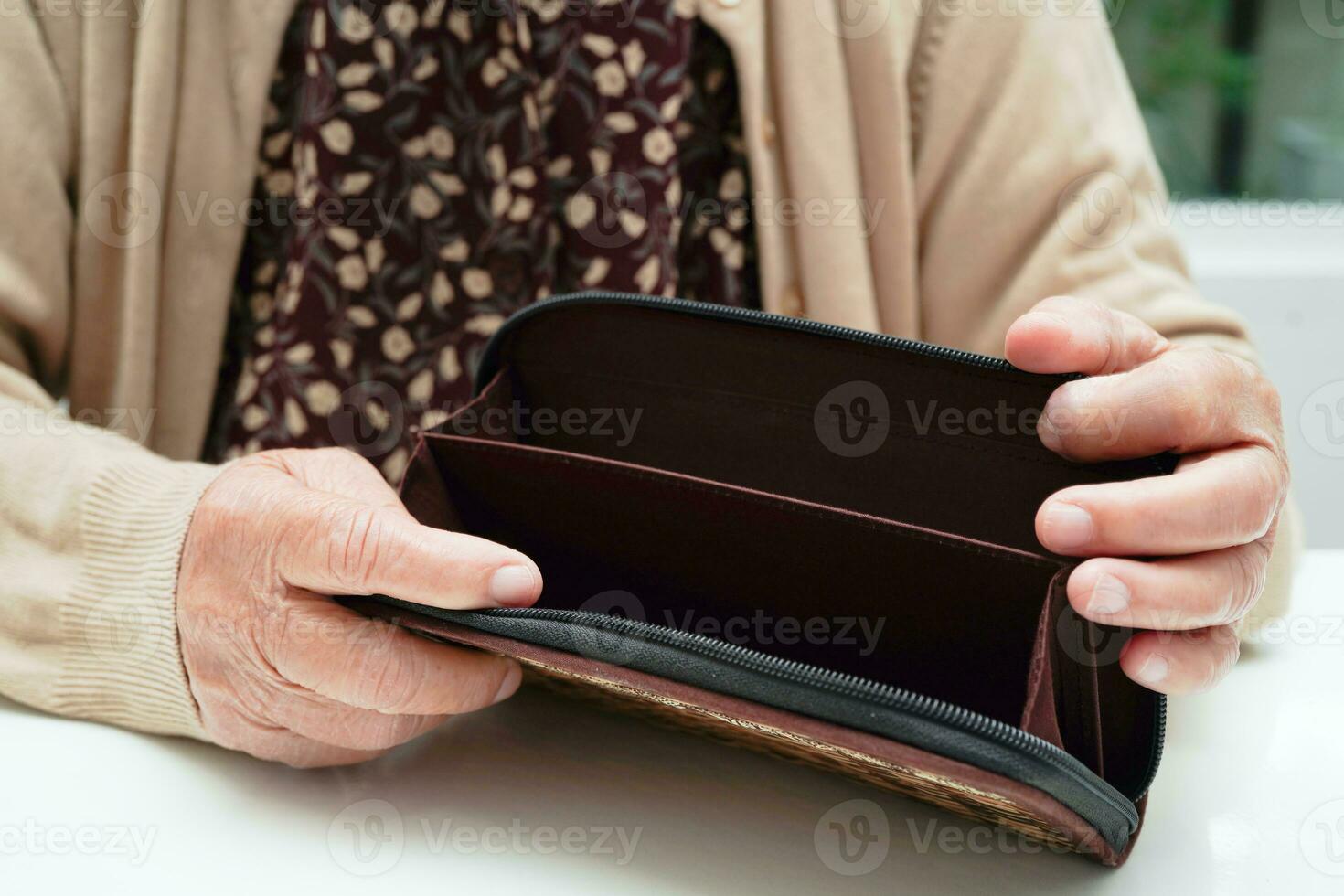 Retired elderly woman counting coins money and worry about monthly expenses and treatment fee payment. photo