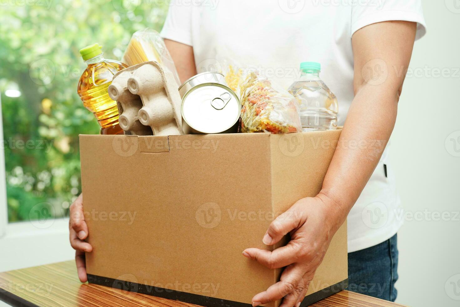 Foodstuffs in donation box for volunteer to help people. photo