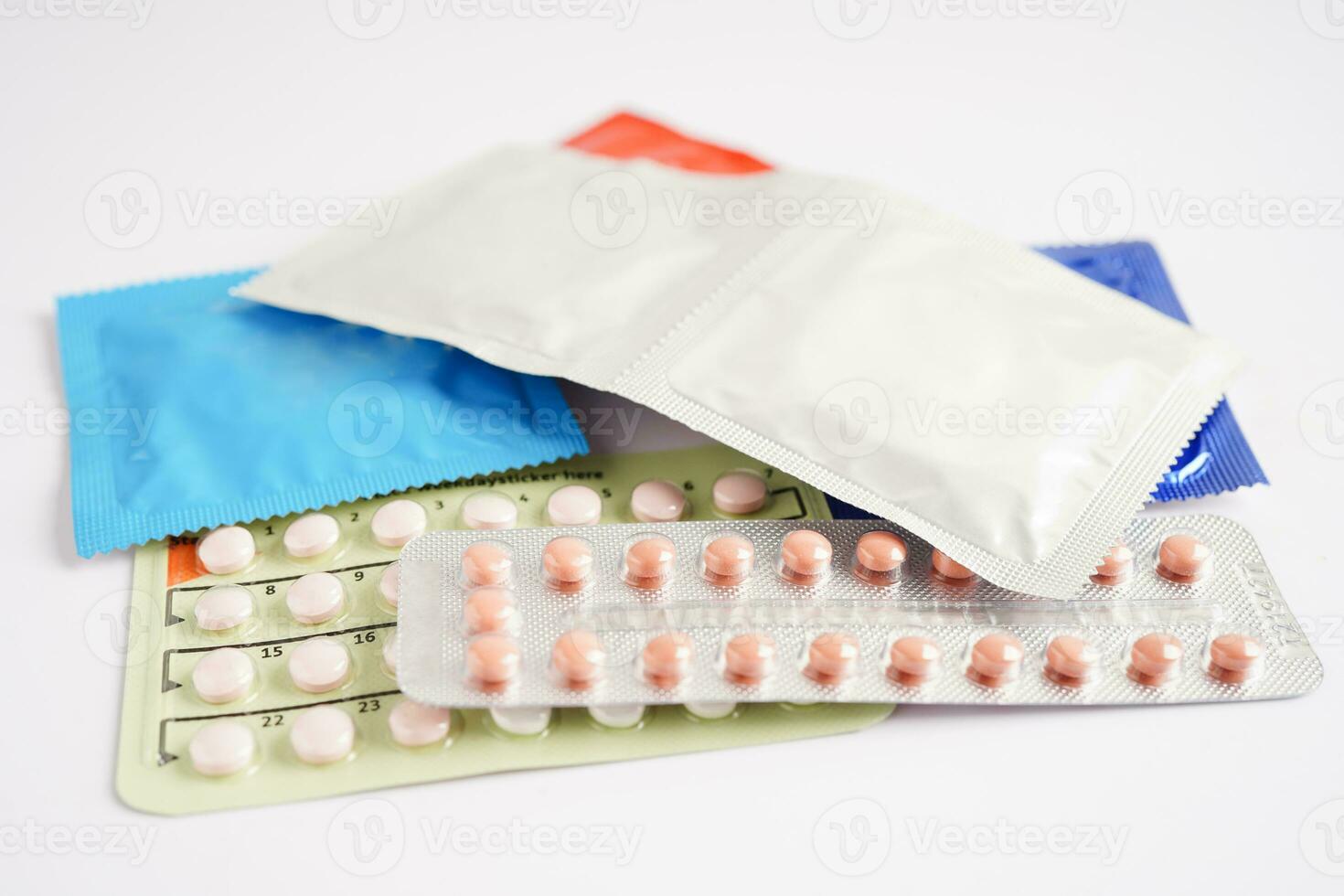 Pregnancy test and condom for female on calendar, ovulation day. photo