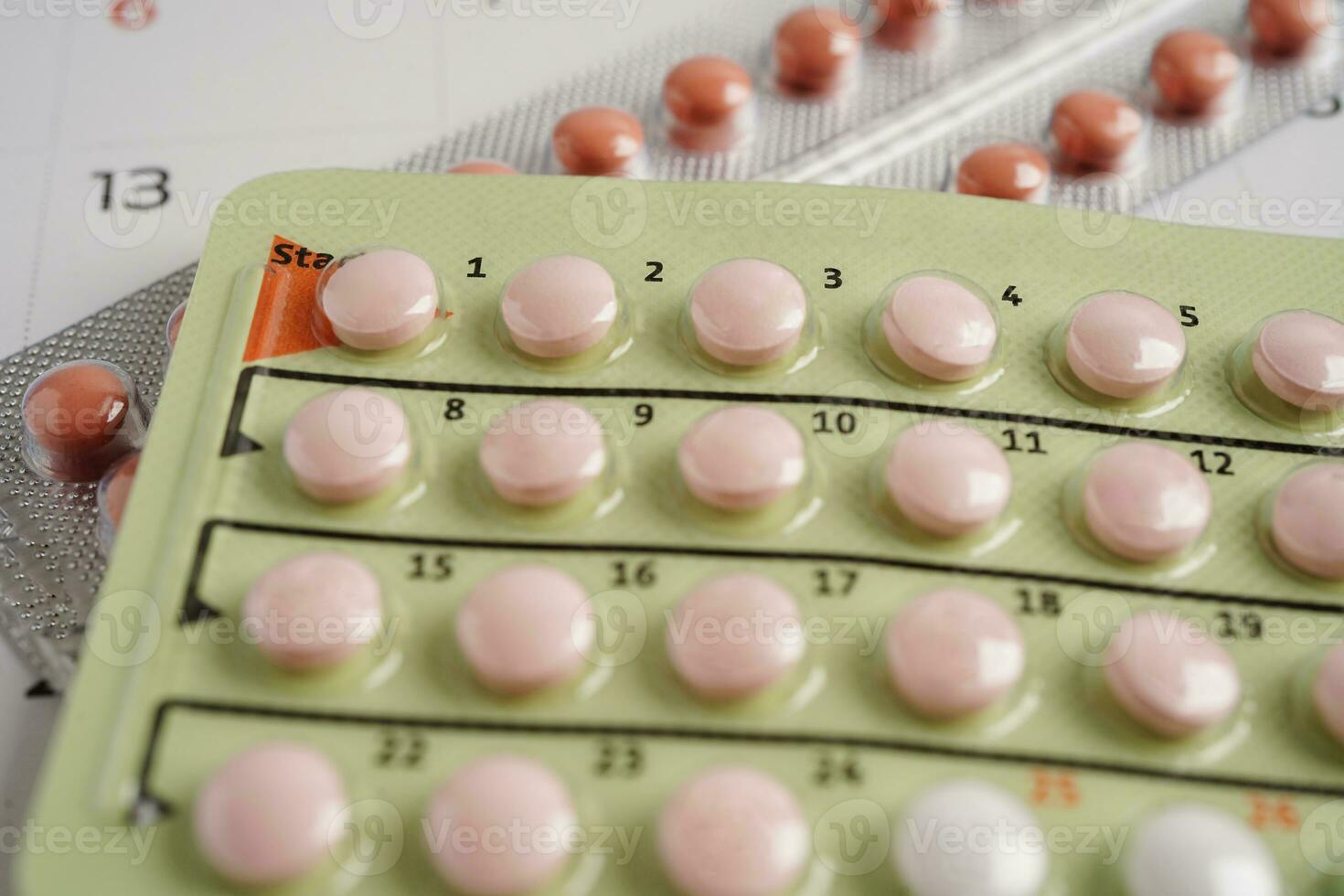 Birth control pills for female on calendar, ovulation day. photo