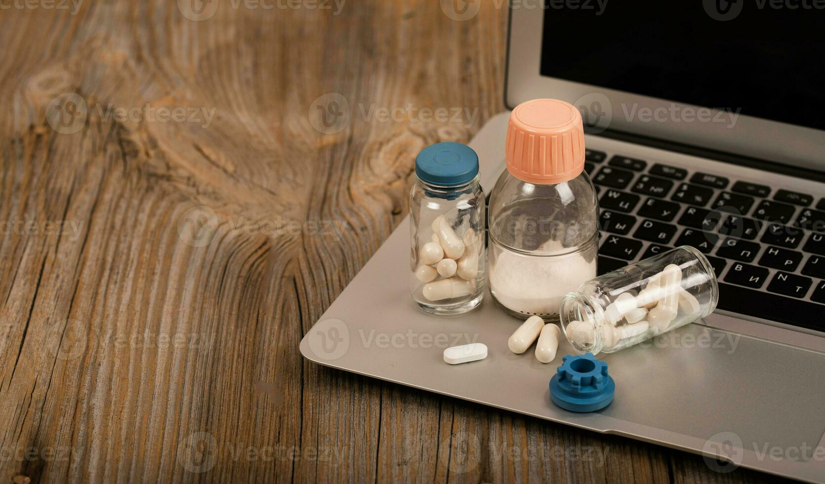 Set of medication on laptop. photo