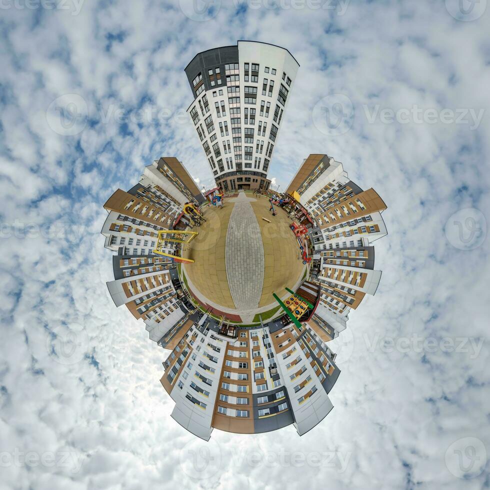 tiny planet in blue sky with clouds in city center near modern skyscrapers or office buildings. Transformation of spherical 360 panorama in abstract aerial view. photo