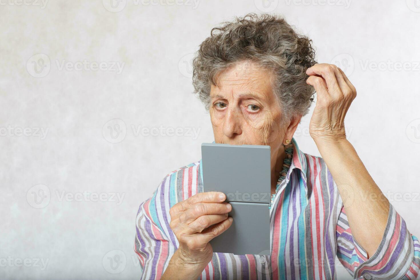 Old woman and a mirror photo