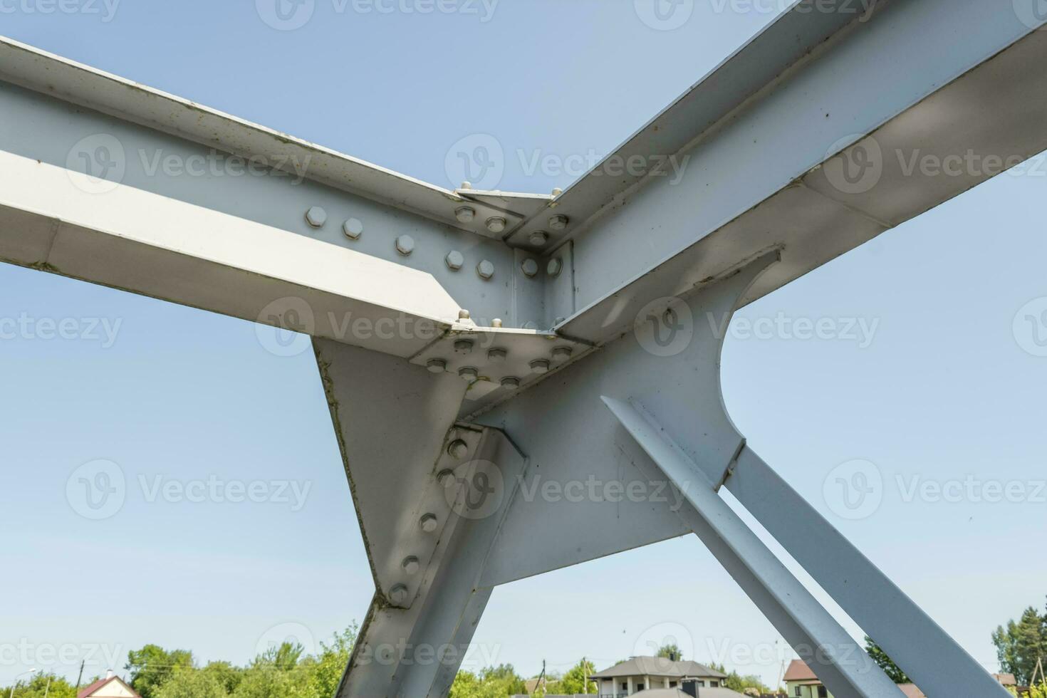 Bolts and nuts on metal plates of steel structure of heavy duty straight crossbar of frame and bridge support photo