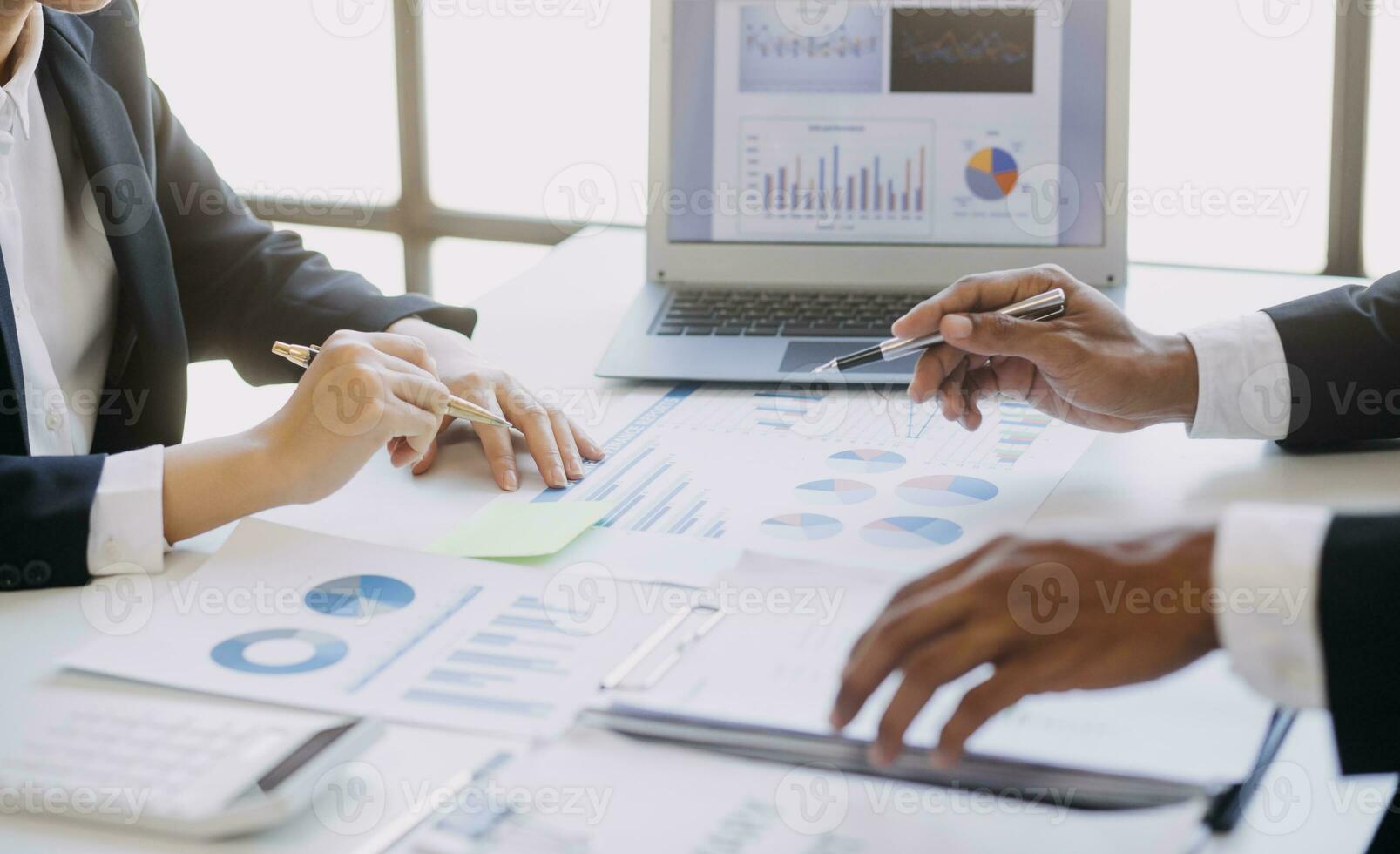 A couple is approaching a housing project to buy, and they are discussing details and advice with a salesperson in a housing project. Real estate trading ideas with couples. photo