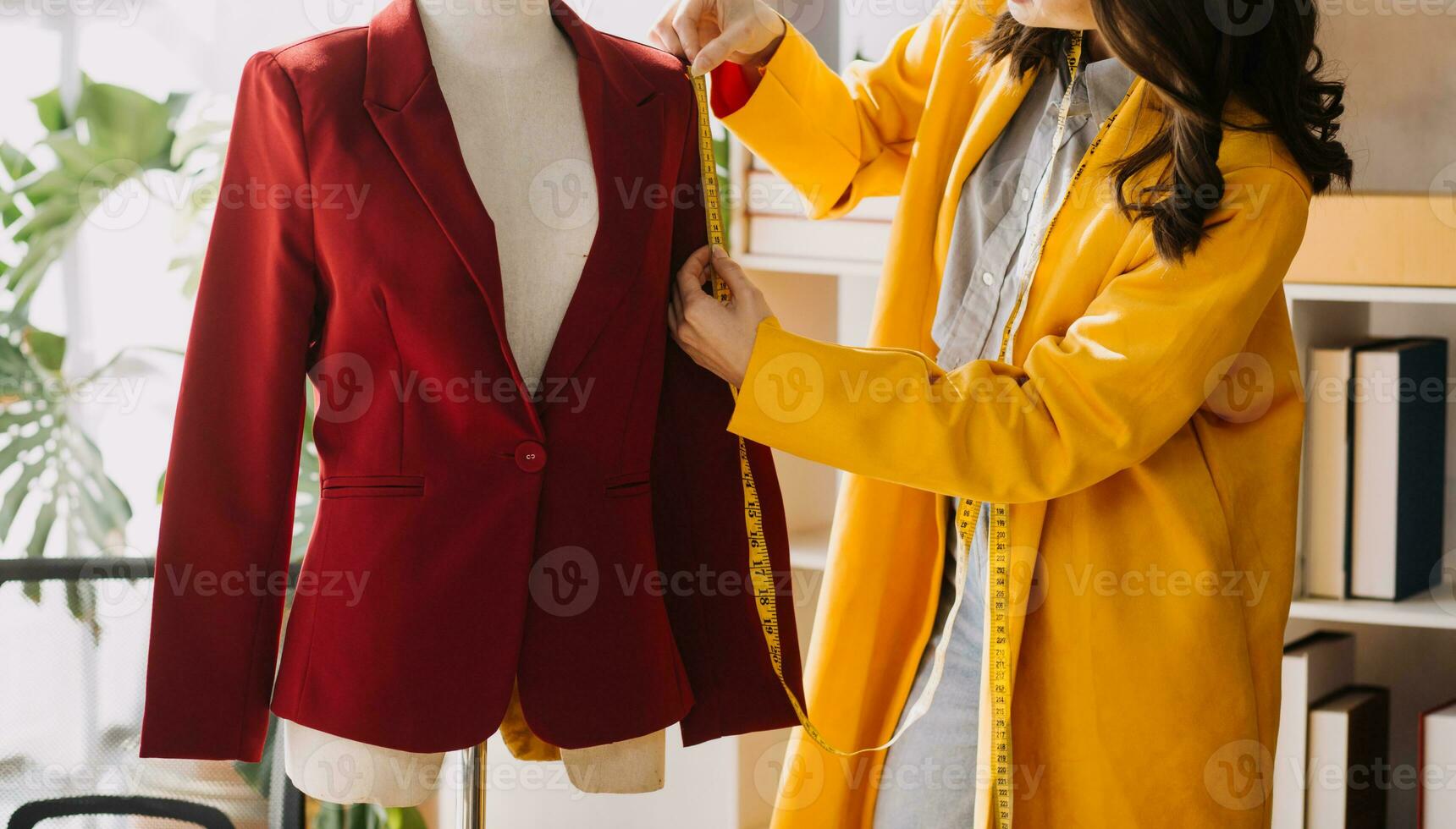 Fashion designer l young asian woman working using laptop, tablet and smiling while standing in workshop Responding on business photo