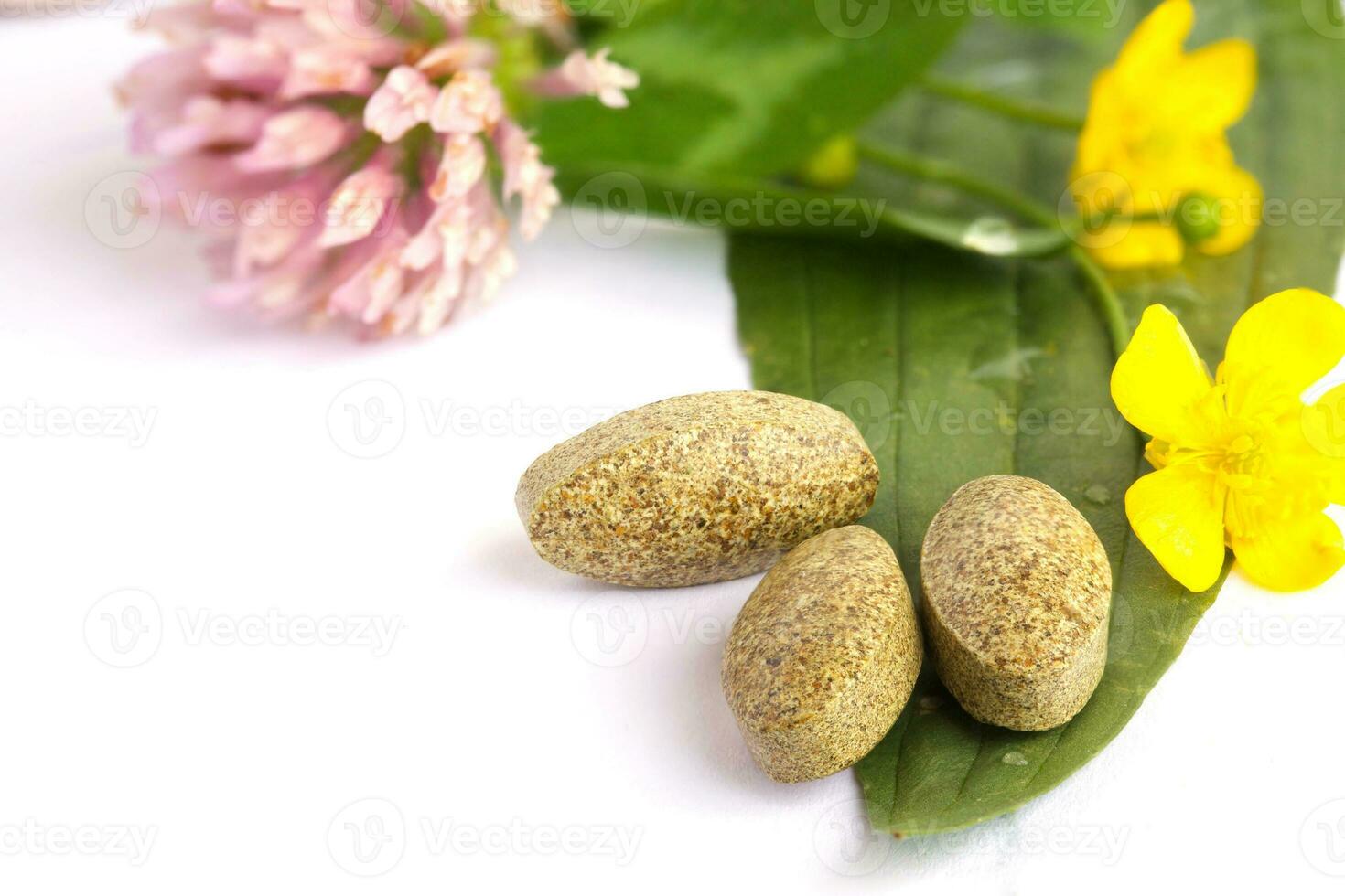 Herbal pills on a white background. Closeup photo