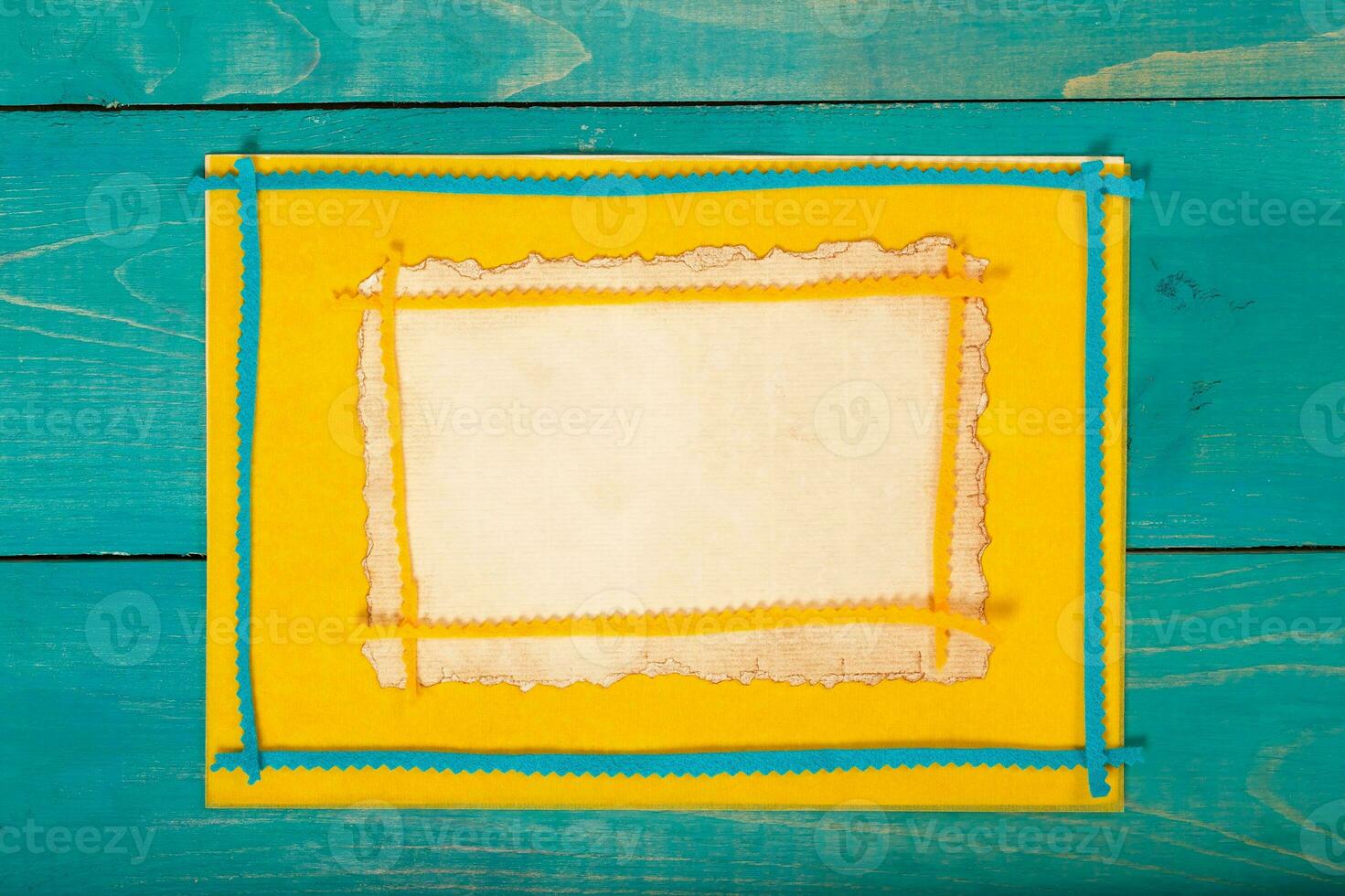 Yellow felt fabric on a wooden surface.Top view photo