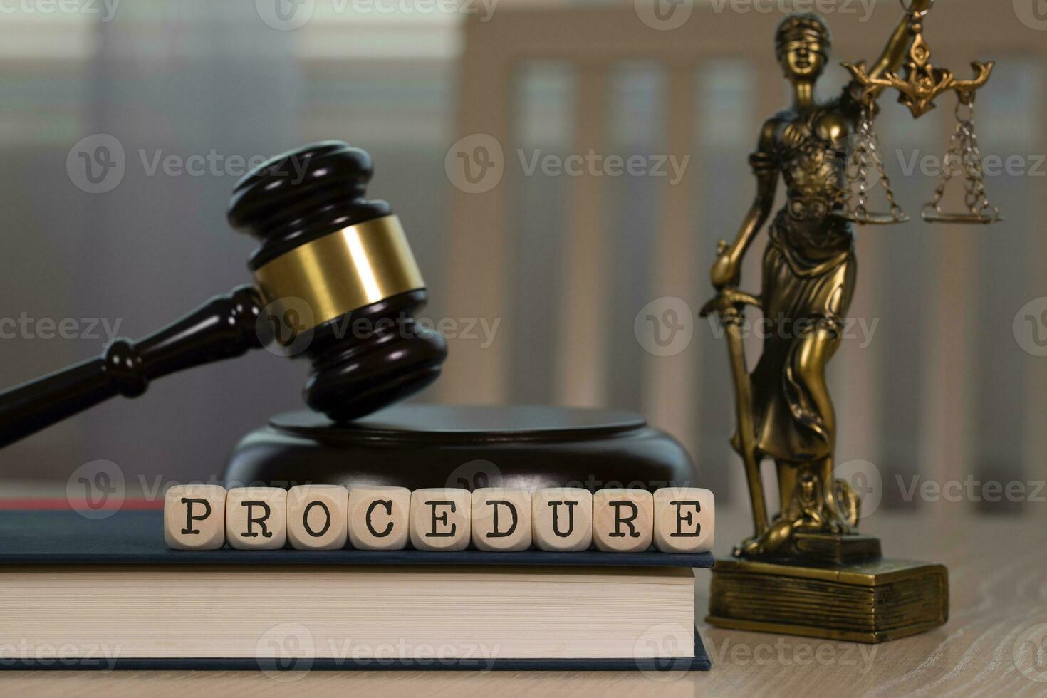 Word PROCEDURE composed of wooden dices. Wooden gavel and statue of Themis in the background. photo