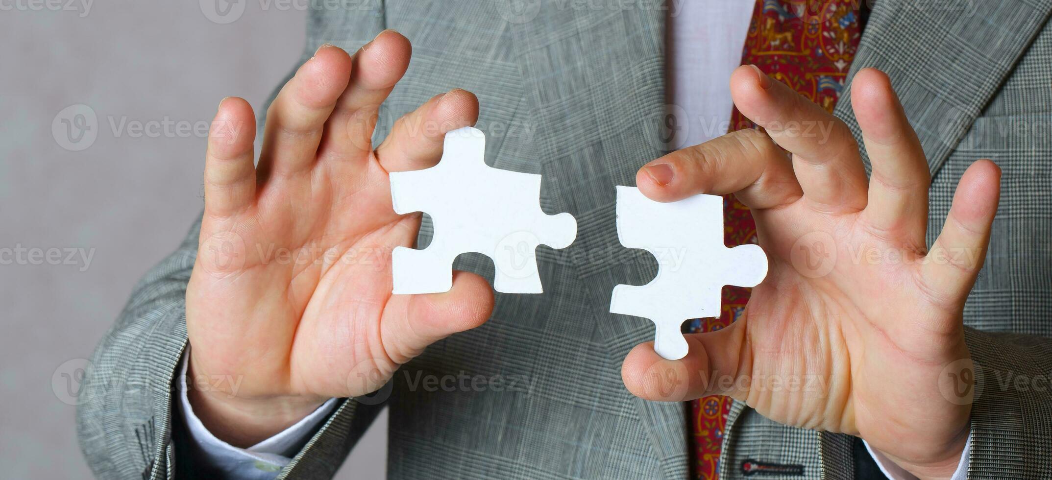 Puzzle in the hands of a man in a classical costume photo