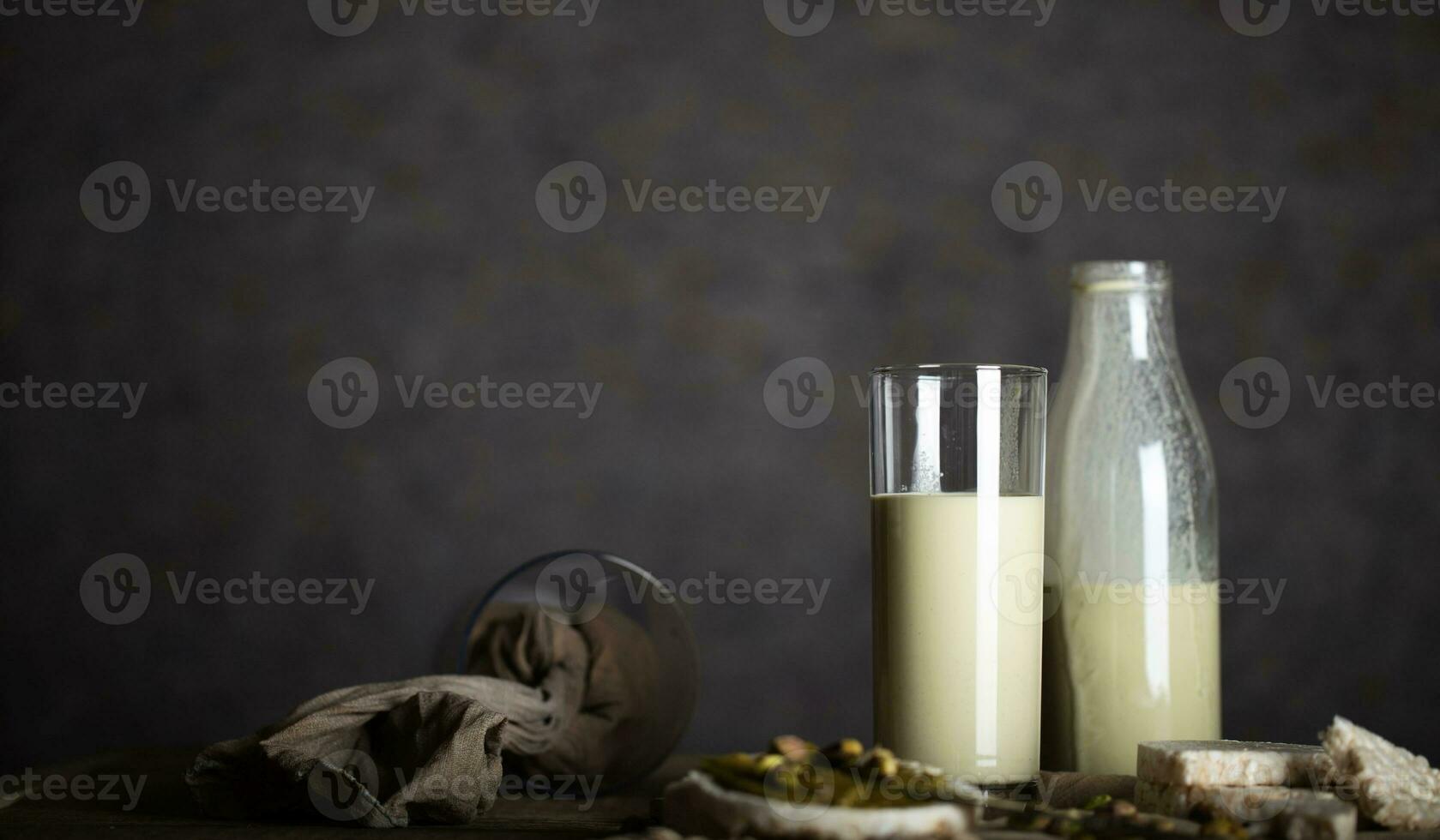 Homemade pistachio nut milk in a glass bottle. photo