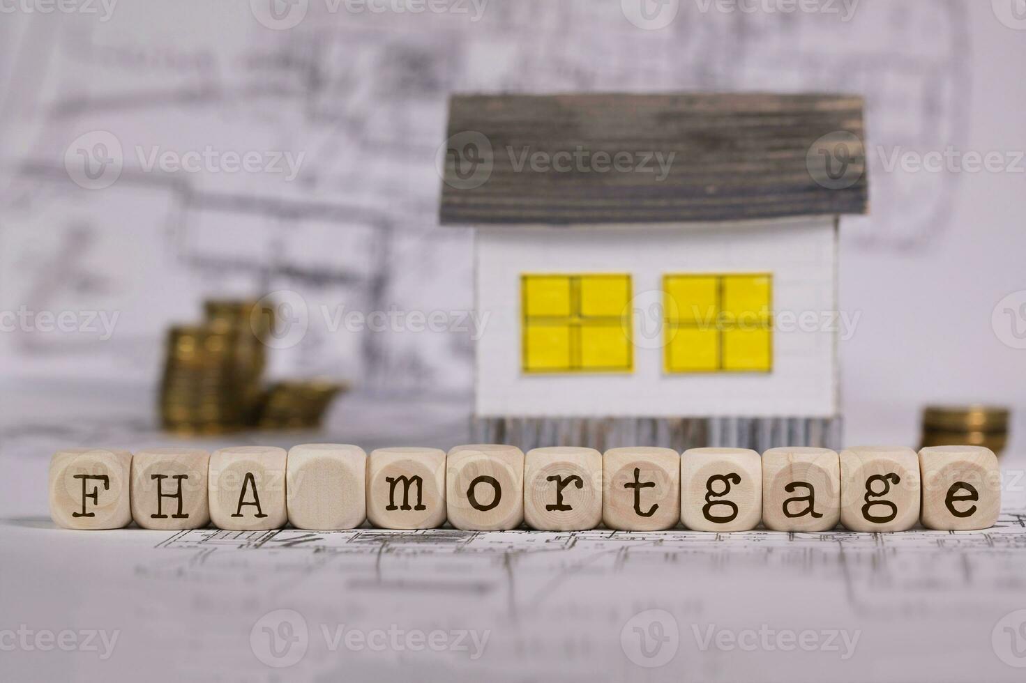 Abbreviation FHA mortgage composed of wooden letters. Small paper house in the background. photo