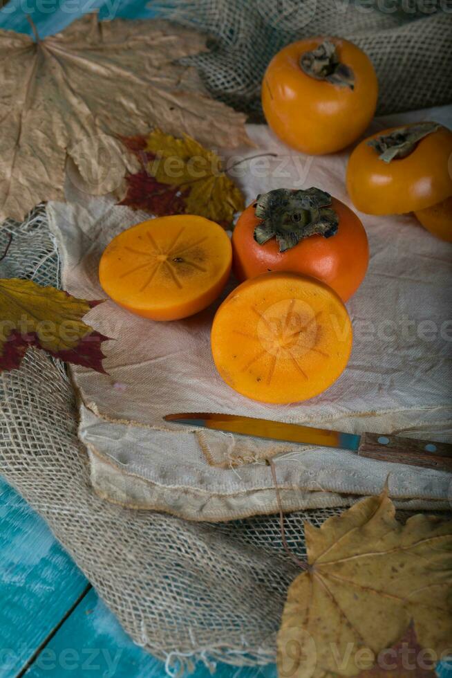 Persimmon fruit on a sackcloth. photo