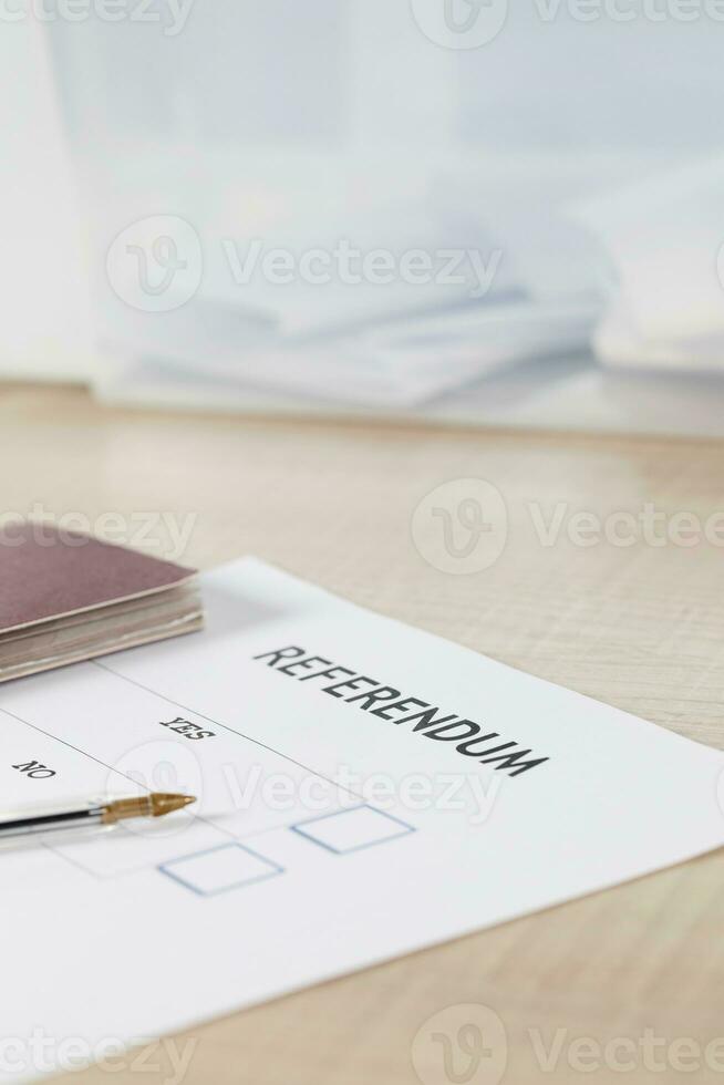 Referendum ballot paper, black pen, and passport on the table. photo