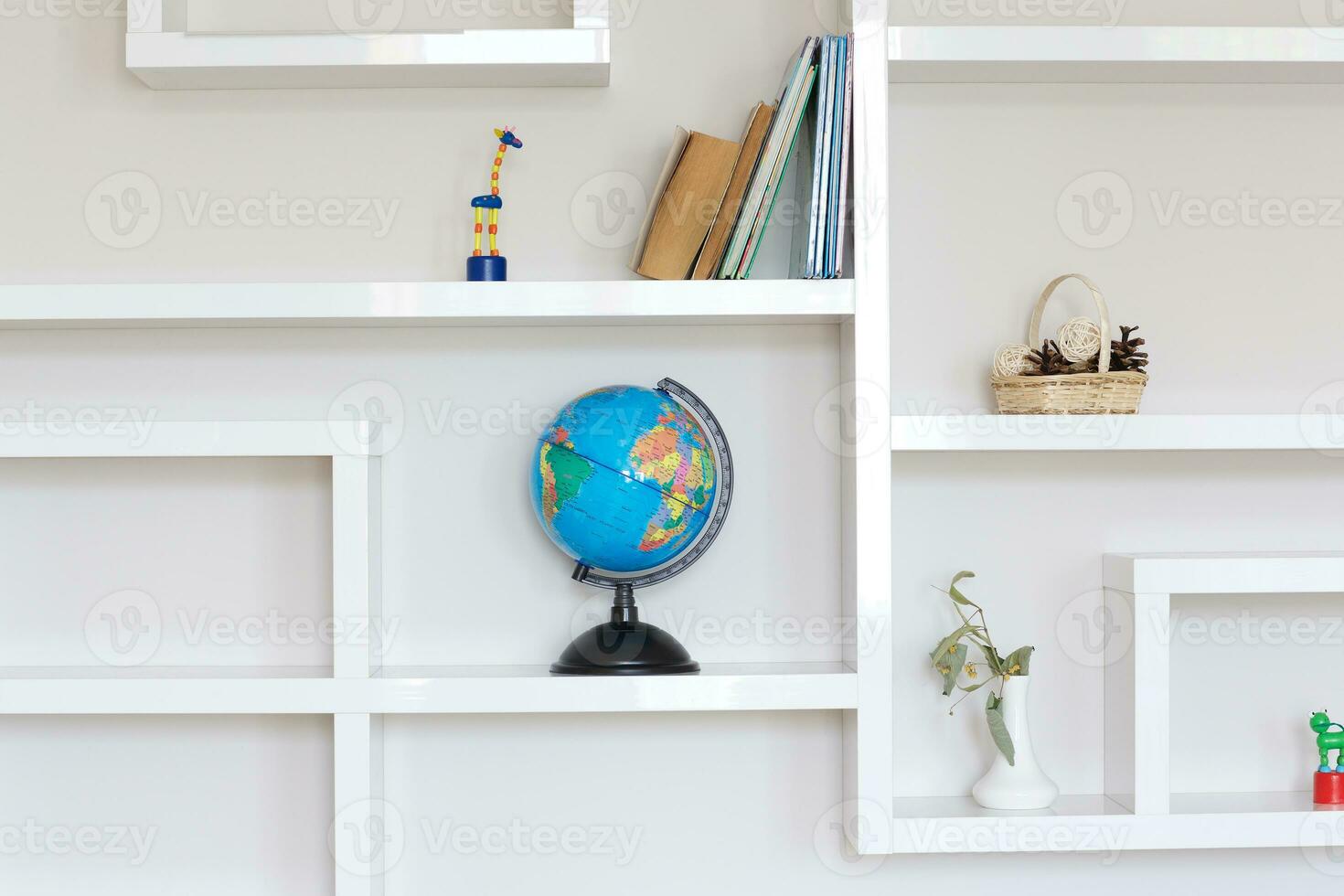 Colorful paper globe on a book shelf. photo